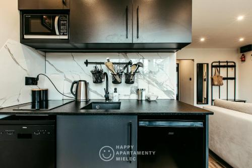 a kitchen with a sink and a counter top at Happy Place - ApartamentyHappy pl in Mielec