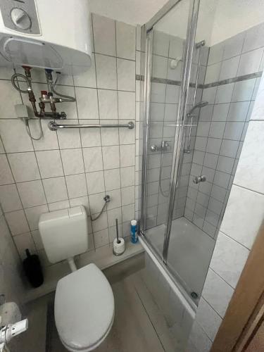 a bathroom with a toilet and a glass shower at Pension Christianstraße in Bernburg