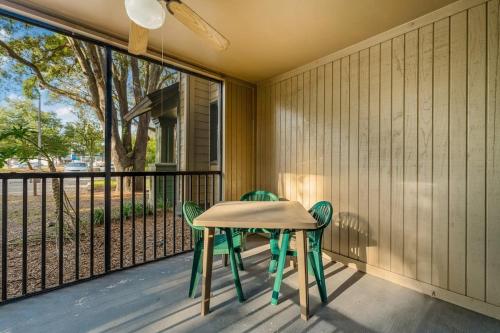 a table and two chairs on a porch with a window at Family condo near Lettuce Lake in Tampa