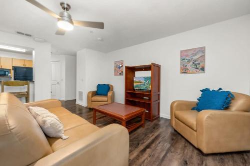 a living room with two couches and a table at Family condo near Lettuce Lake in Tampa