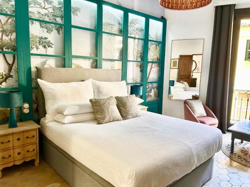 a bedroom with a large bed with a blue headboard at Dog Admiral - Urban Guest House in Palma de Mallorca