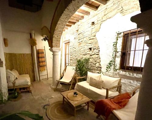 a living room with a stone wall at Arcos de Tarifa, Casco historico in Tarifa