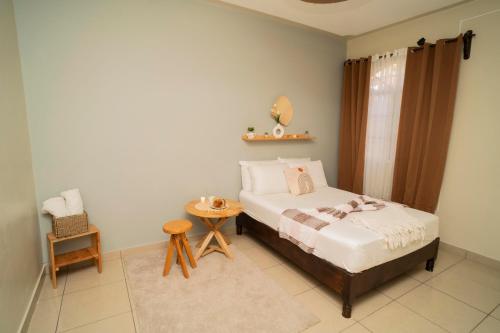 a bedroom with a bed and a table and a chair at Cozy Renting Casa in Santa Rosa de Copán