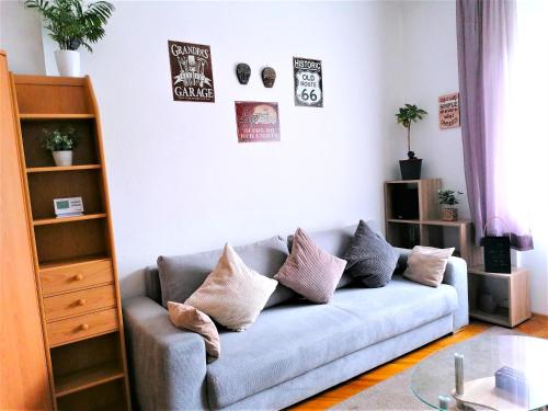 a living room with a couch with pillows on it at A jump from downtown in Budapest
