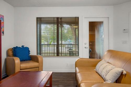a living room with a couch and a chair and a table at 4BD 2 MI to USF Free Pool + 24 Hour Gym in Tampa
