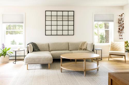 a living room with a couch and a table at Pine Point 4BR Beach House, Walk to Sand & Ocean in Scarborough