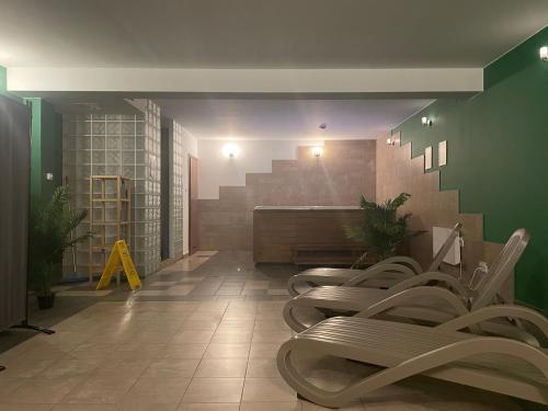 a waiting room with a row of chairs and stairs at Apartament Gawra Sauna & Jacuzzi in Zakopane