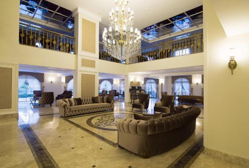 a large living room with couches and a chandelier at Svalinn Hotel in Izmir