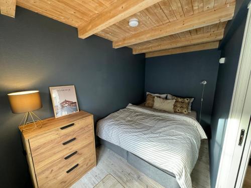 ein Schlafzimmer mit einem Bett und einer Holzdecke in der Unterkunft Cozy backyard apartment in Trondheim