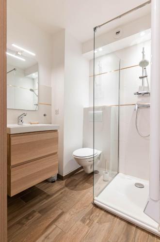 une salle de bain avec toilettes et douche en verre dans l'établissement Flots Bleus, à Palavas-les-Flots