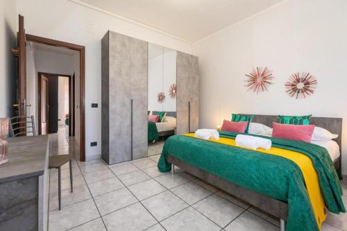 a bedroom with a large bed and a living room at Medea home in Catania