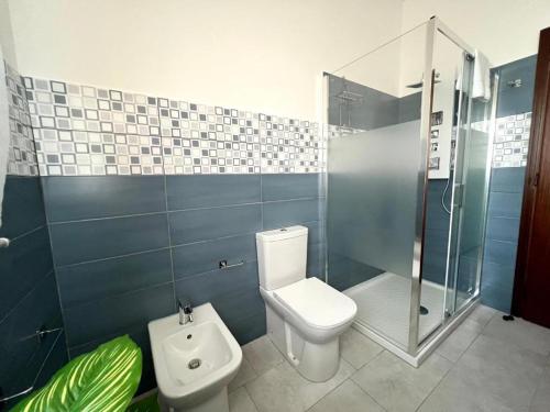 a bathroom with a toilet and a shower at Medea home in Catania