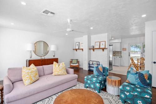 a living room with a couch and two chairs at Baron's Bungalow with hot tub & pet friendly in Fredericksburg