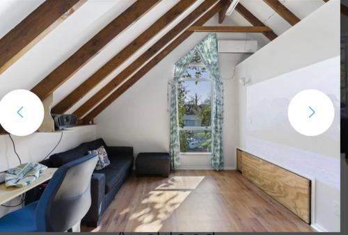 a living room with a couch and a table at The Lookbox Studio in Auckland