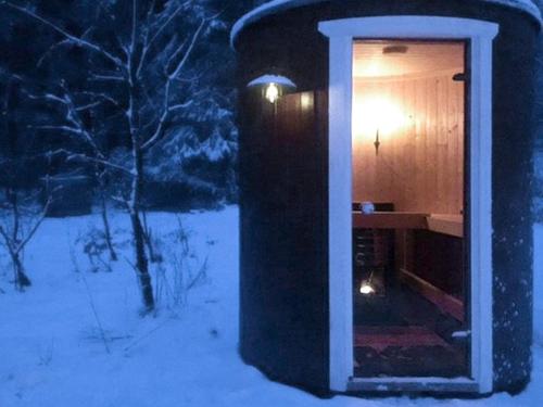 a small house with a light inside of it in the snow at 8 person holiday home in Hestra-By Traum in Hestra