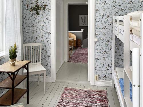 a childs room with a hallway with floral wallpaper at 4 star holiday home in HJORTKVARN-By Traum in Haddebo