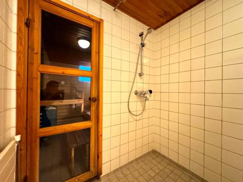 a bathroom with a shower with a window at DownTown Rooms And Sauna in Helsinki
