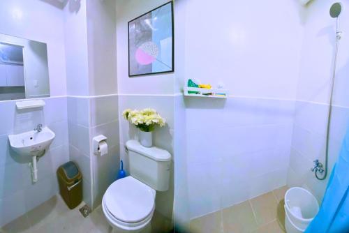 a bathroom with a toilet and a sink at Plumera Condo Near Mactan Airport, Mall and School in Lapu Lapu City