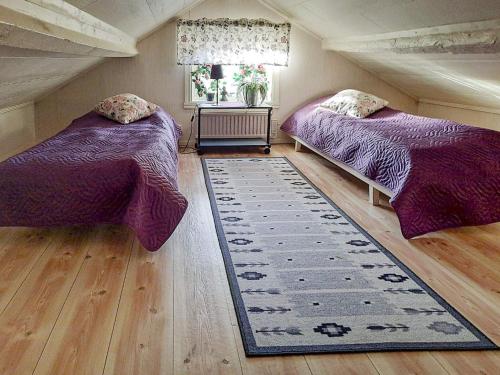 a bedroom with two beds and a rug at 6 person holiday home in LYSEKIL-By Traum in Lysekil