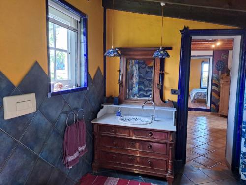 a bathroom with a sink and a mirror at Casa Mosaico, sunset and garden in Los Llanos de Aridane