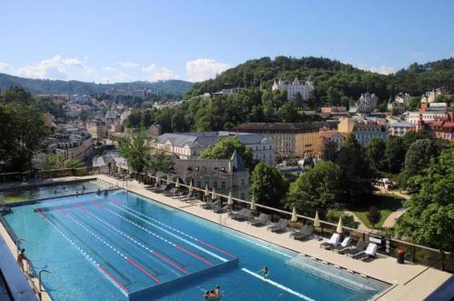 a large swimming pool on top of a city at Boutique Apartment Owned by Emperor Peter The Great With 2 Balconies & Jacuzzi in Karlovy Vary