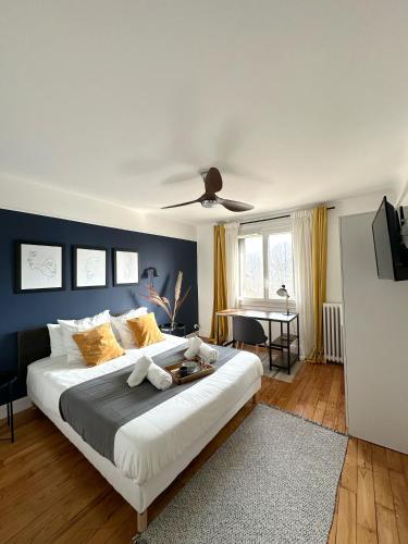 - une chambre avec un grand lit et un mur bleu dans l'établissement T3/2 douches/Parking/Villejuif/Paris/IGR, à Villejuif