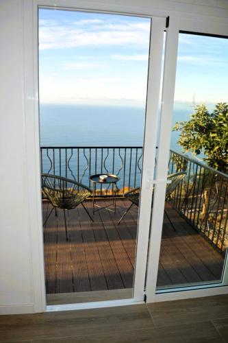 a sliding glass door with a balcony with a table at calMar Tenerife 1 in Los Realejos