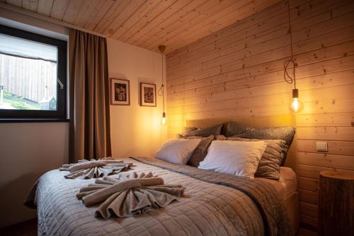 a bedroom with a bed with towels on it at VILLETTA Apartmán in Liptovský Mikuláš