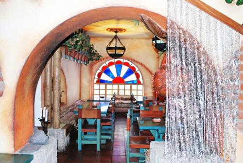 a dining room with a table and a stained glass window at Hotel Vieja Cuba in Quito