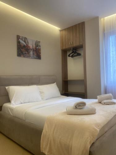 two beds sitting next to each other in a bedroom at guesthouse apartments in Tirana
