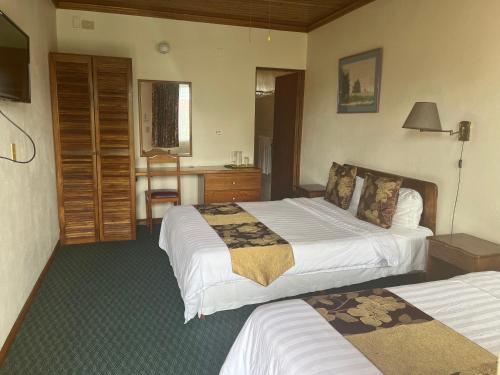 a hotel room with two beds and a bathroom at Soluxe el sesteo in San José