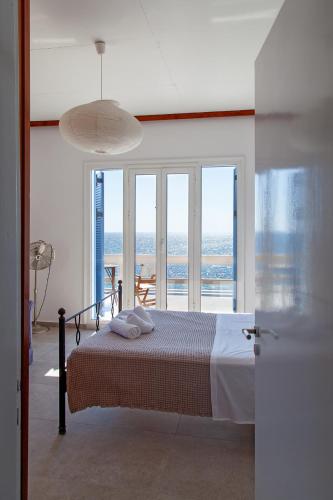 a bedroom with a bed with a view of the ocean at Villa Moby Dick in Mitikas