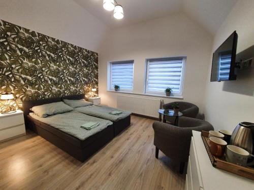1 dormitorio con 1 cama, 1 sofá y 1 silla en MTK Pokoje i Apartamenty, en Smołdzino