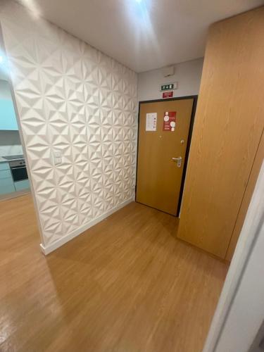 an empty room with a door and a wooden floor at Francisco Barbosa in Estarreja