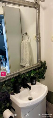 a bathroom sink with a large mirror above it at jm-Sutomišćica-holiday house on the beach in Sutomišćica