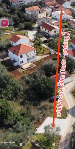 an aerial view of a residential neighborhood with a red sign at jm-Sutomišćica-holiday house on the beach in Sutomišćica