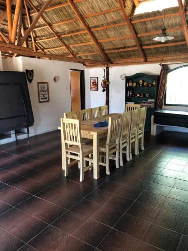 a dining room with a table and chairs and a piano at Casa de campo Rincon in San José del Rincón
