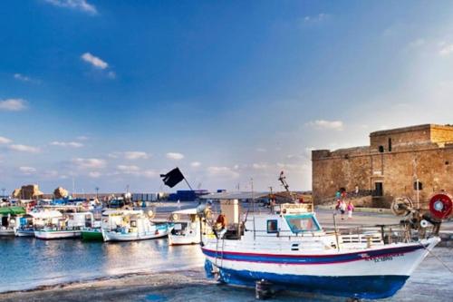 a boat is docked in a harbor with other boats at Comfy Apartment Near Paphos in Yeroskipou