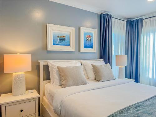 a bedroom with a bed with two lamps and a window at Villa Cardona, Dana Point great location, energy close to the beach/Harbor in Dana Point