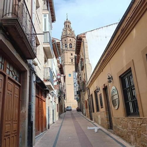 a city street with a clock tower in the distance at Piso en plena Herradura. in Haro