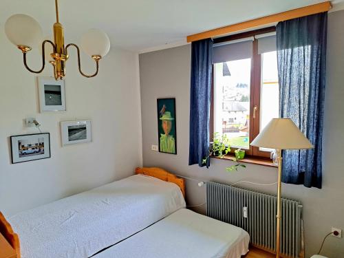 a bedroom with two beds and a window at Comfy and central in Bohinj