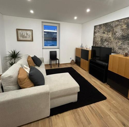 a living room with a couch and a flat screen tv at Alojamento Cabeço de Vide in Cabeço de Vide