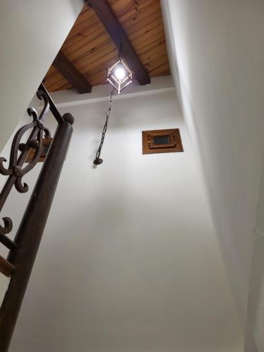 a stairway with a light hanging from a ceiling at El Refugio de Gredos in Guisando