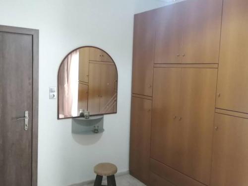 a bathroom with a mirror and a wooden cabinet at Blue swing chair apartment in Perea