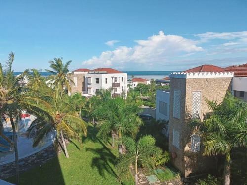 an aerial view of a resort with palm trees and the ocean at Stunning 2 Bed Room Unit with Ocean View in Mariakani