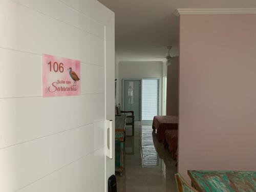 a room with a bed and a sign on the wall at São Francisco Flats in Guapé