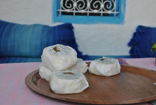 three towels on a tray on a table at Ferme Dar Aicha green Bellouta in Bellouta