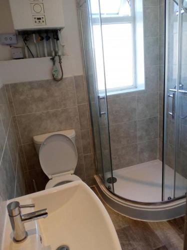 a bathroom with a toilet and a shower at Double-bed (G4) close to Burnley city centre in Burnley