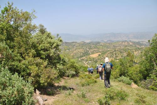 a group of people walking on a mountain trail at Ferme Dar Aicha green Bellouta in Bellouta