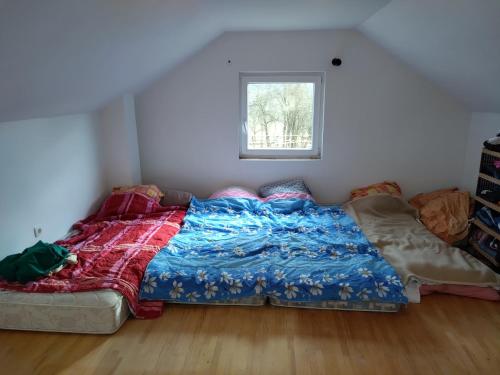 a bed sitting in a room with a window at Vikendica Varosiste Rogatica in Rogatica